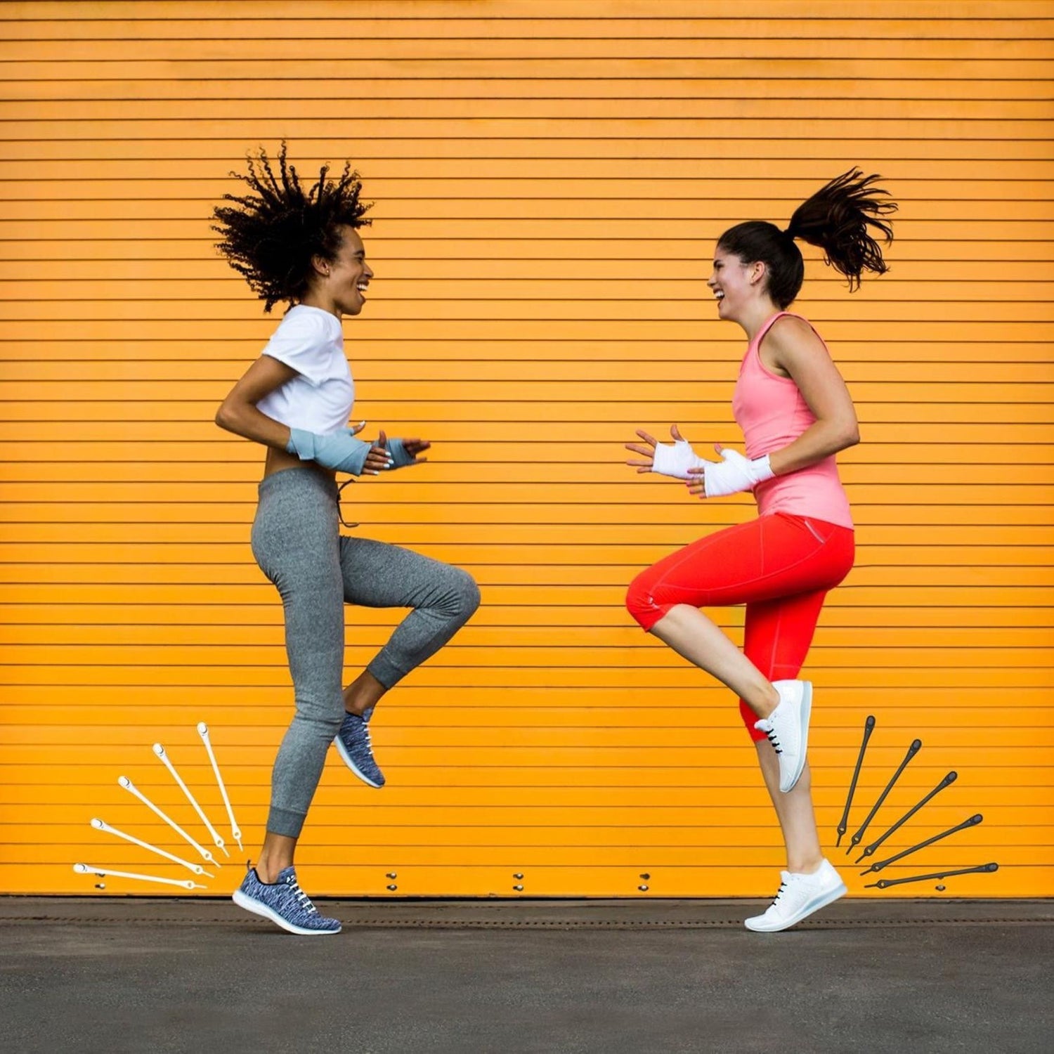 Two young women exercising against orange background